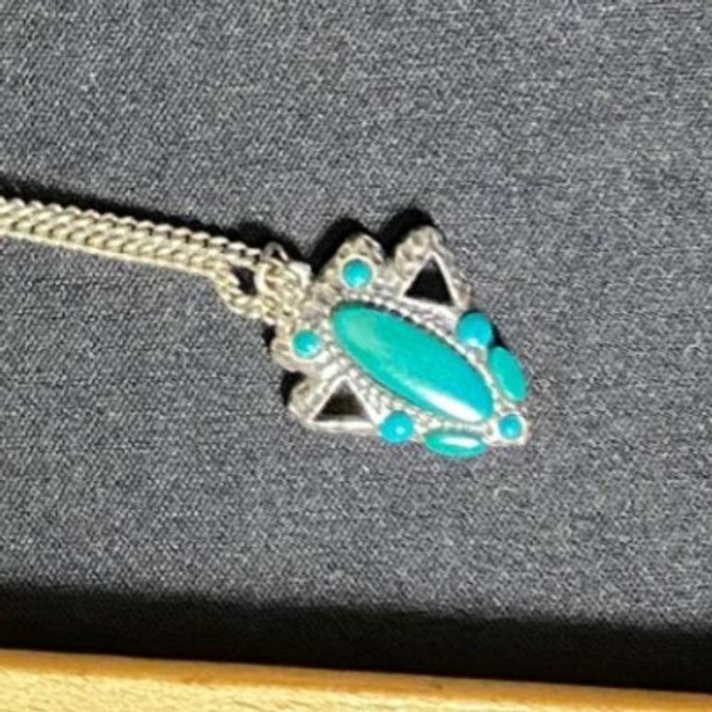 Silver-tone pendant necklace with faux turquoise stones in a tribal/boho style